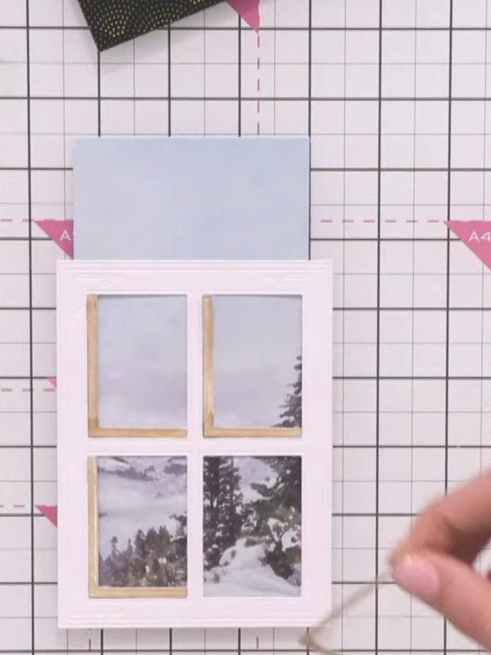 Step 8: Adhere all the shadow elements flat to the card base. Mount the window frame on foam tape and position it over