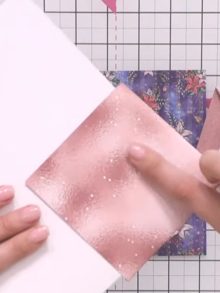 Step 3: Take the top left corner of the white card and fold it down to meet the top edge of the pink glitter paper pan