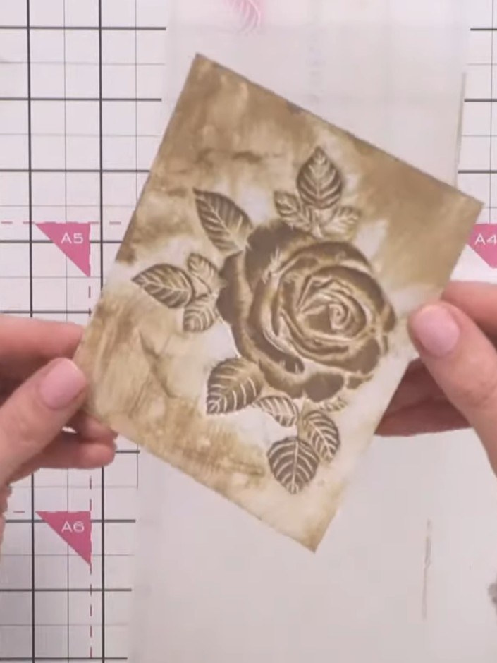 Step 12: Alternatively, use the coordinating die to cut out the rose design from the embossed card. Layer the die-cut r