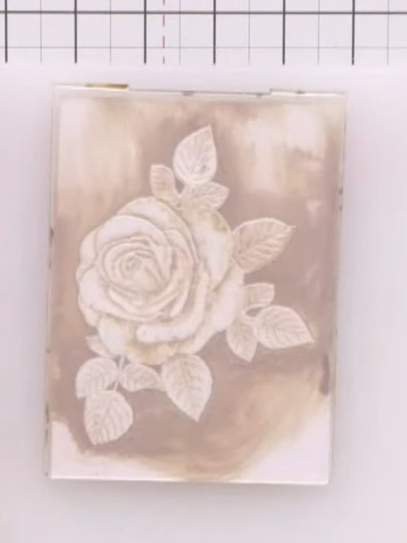 Step 6: Lightly wet your embossed card with water. Use a brush to apply yellow ink to the centre of the rose flower.