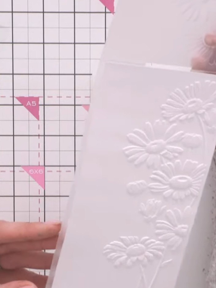 Step 2: Place your card into the embossing folder from the Daisy Meadow bundle. Run the card through your die-cutting 