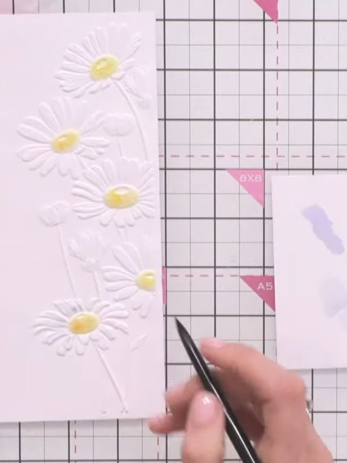 Step 7: Allow the embossed daisy card to dry completely before handling or adding further embellishments.