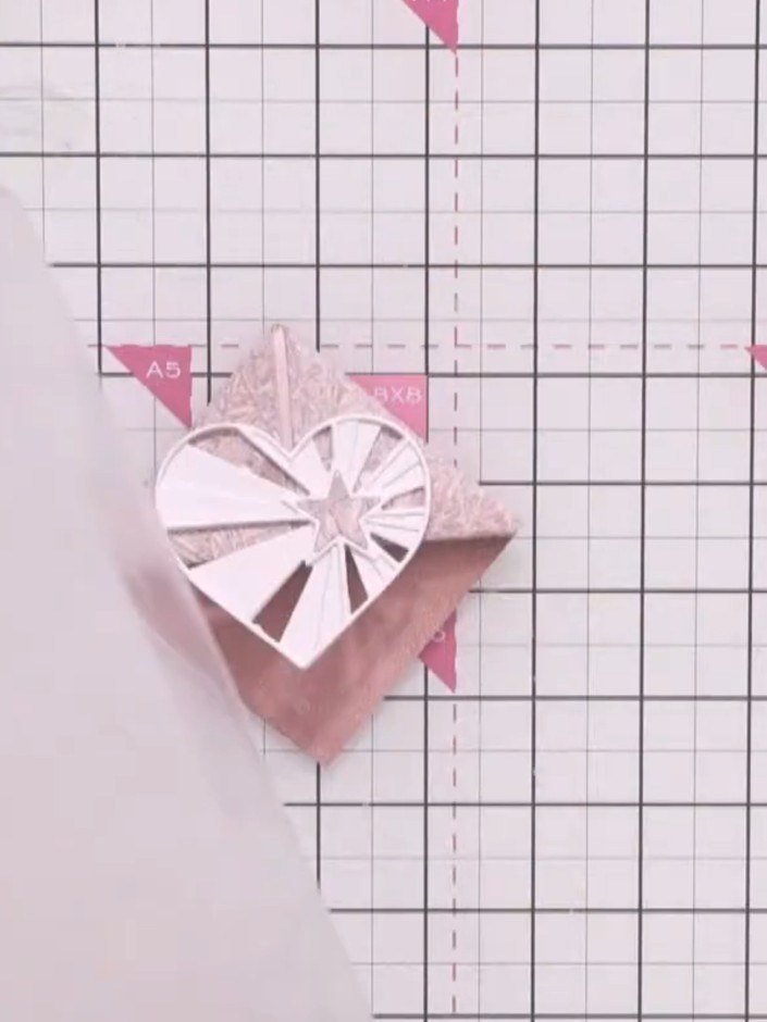 Step 12: Add decorative elements around the heart using glue. This could include washi tape characters, banners, or flo