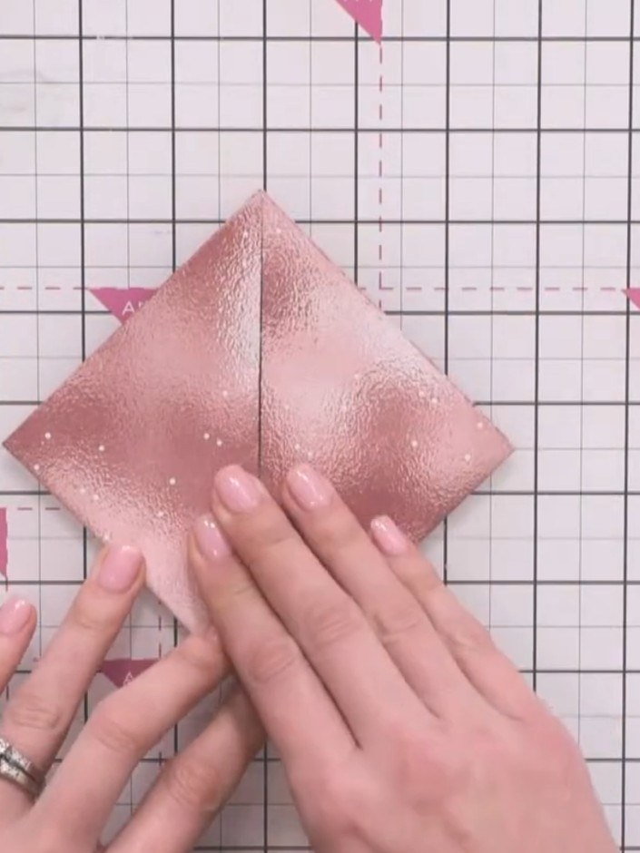 Step 4: Pull the two side flaps back down to their original position, flattening them against the base to return to th