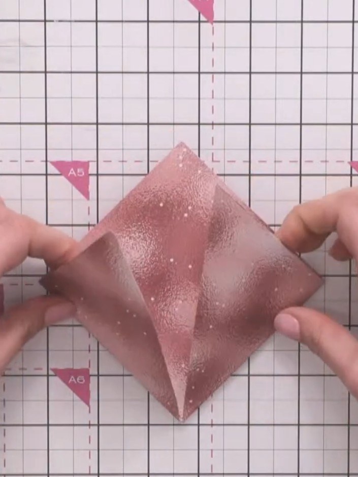 Step 5: Fold the top section down towards the centre and crease it firmly. Press along the fold line to ensure a sharp