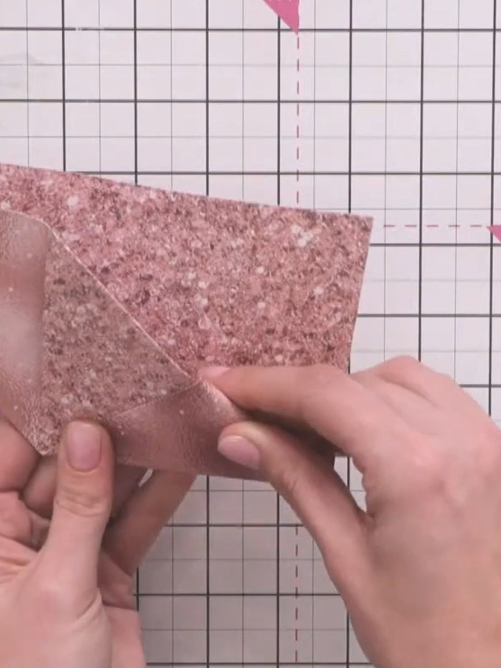 Step 6: Tuck the left flap into the pocket created by the fold on the right side to secure the bookmark shape.