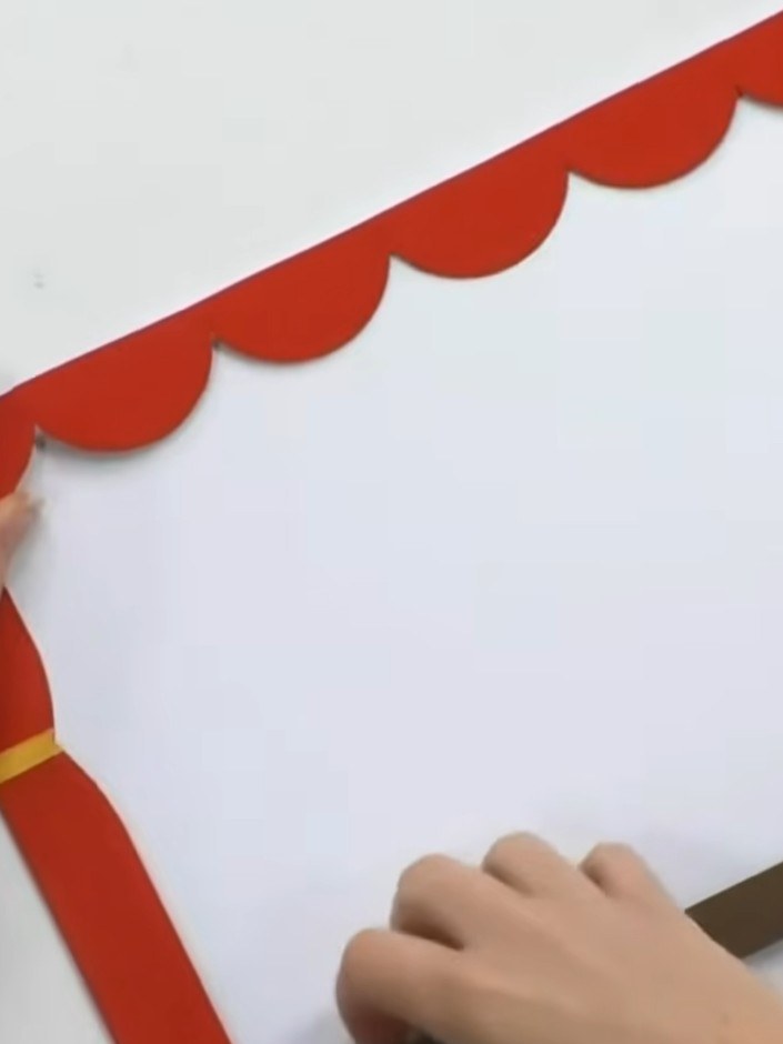 Step 3: Apply double-sided tape to the left side, bottom, and right side of the red theatre frame, leaving the scallop