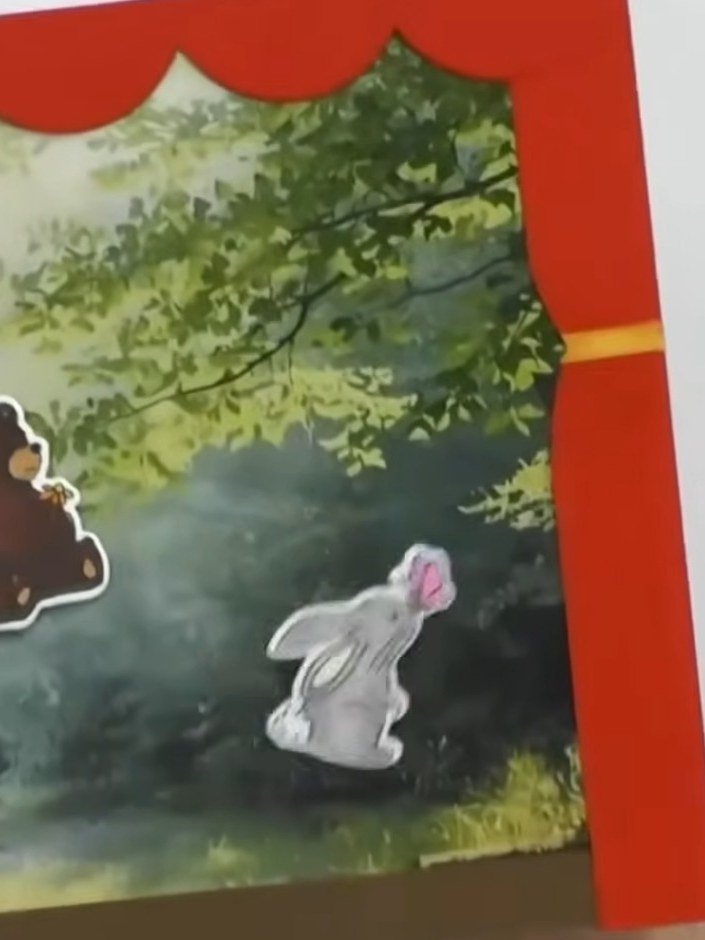 Step 6: Slot the printed scene into the open top of the theatre to change the backdrop. Position your animal magnets o