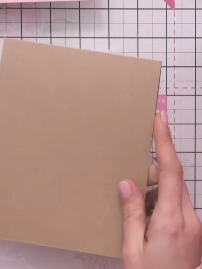 Step 1: Place a card blank underneath your white card on the die-cutting mat as a shim. This helps the stencil emboss 