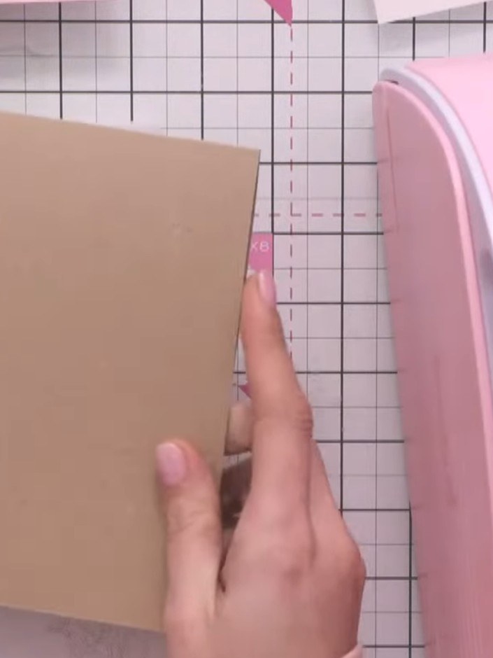 Step 2: Position your heart stencil on top of the kraft card. Run the card and stencil through the die-cutting machine