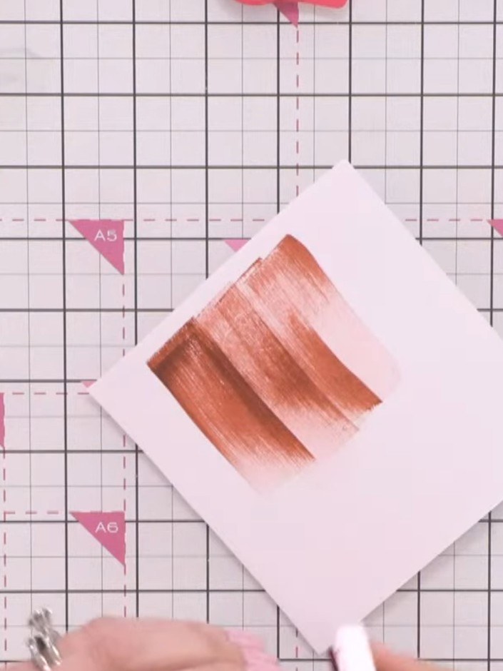 Step 2: Apply multiple colours of reactive, water-based ink randomly across the white card using a sponge applicator. 