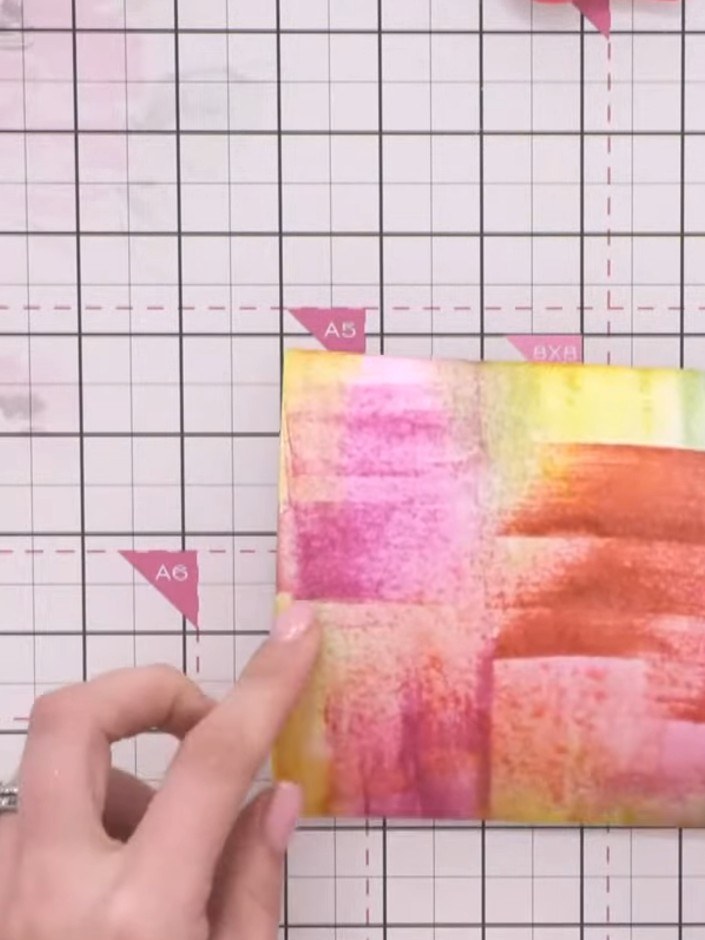 Step 3: Spray the inked card lightly with water to activate and blend the watercolour inks together, creating a soft b