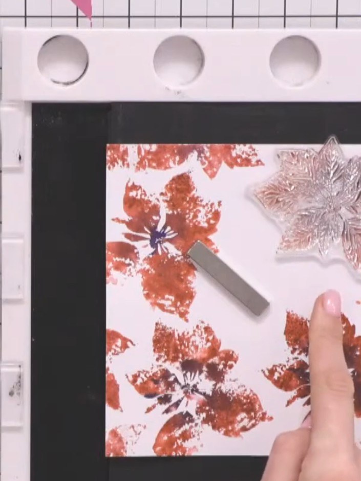 Step 10: Stamp the outline detail over the watercoloured poinsettias using the Merry and Bright stamp set. Offset the s