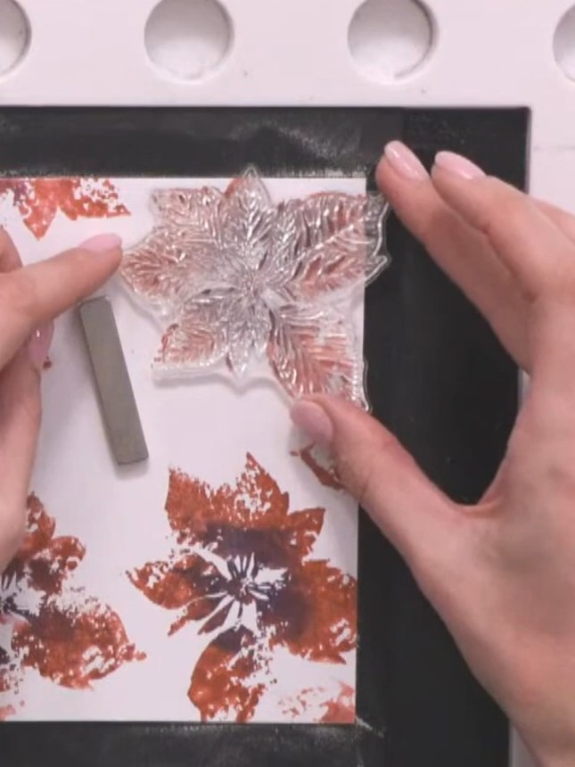 Step 11: Sprinkle embossing powder over the stamped floral design on the card. Ensure the powder covers all the stamped