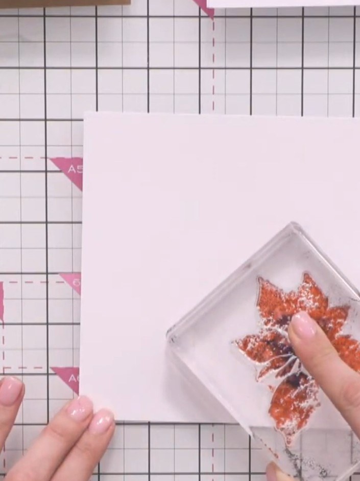 Step 6: Repeat the stamping process with the poinsettia stamp in different areas of the card to build up a bouquet arr