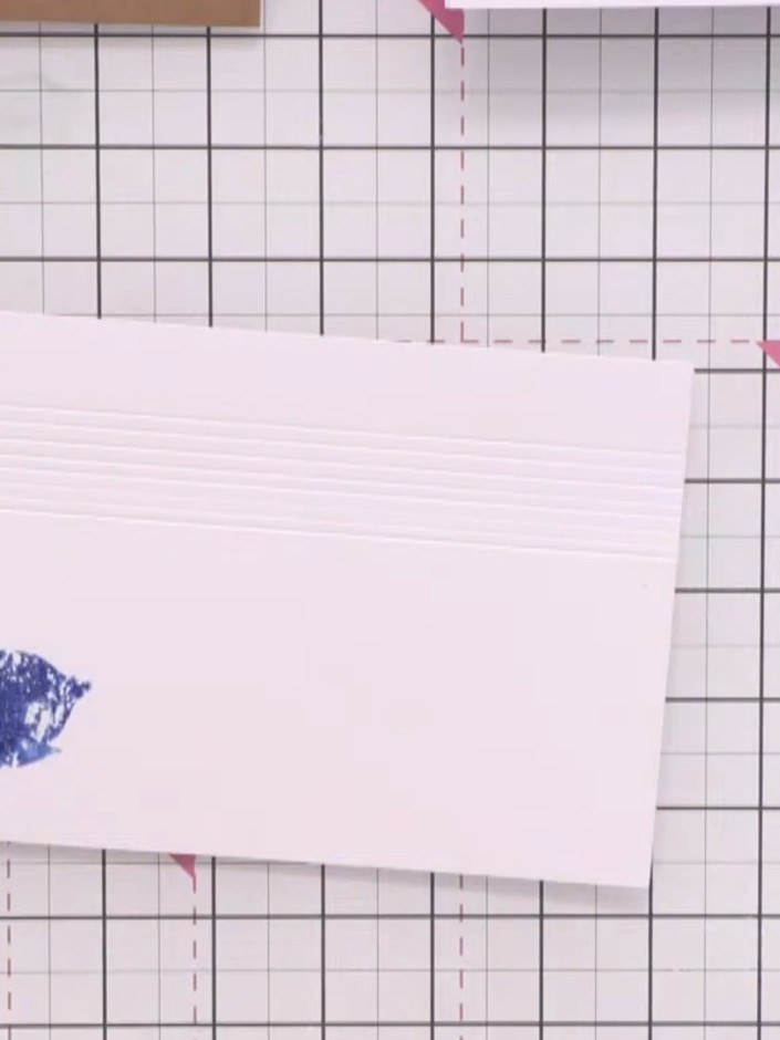 Step 4: Press the stamped poinsettia image onto the right side of the card panel, positioning the blue floral design t