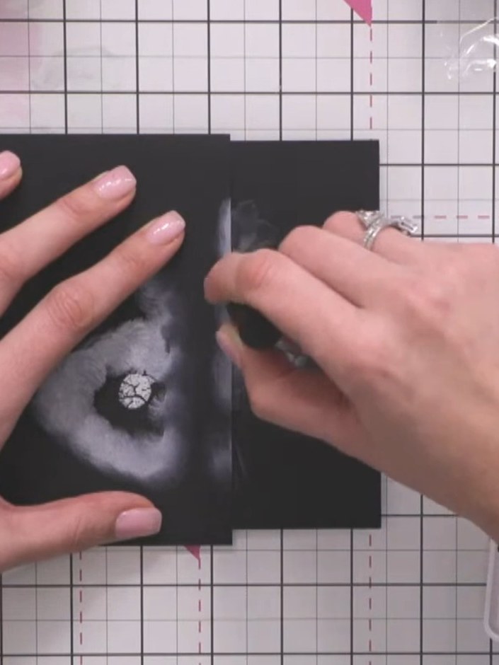 Step 4: Once the white embossing powder has dried, gently wipe away any excess powder from the surface with your finge