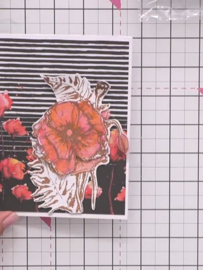 Step 7: Mount the completed layered flower design onto your card base with the black and white striped background. Pos