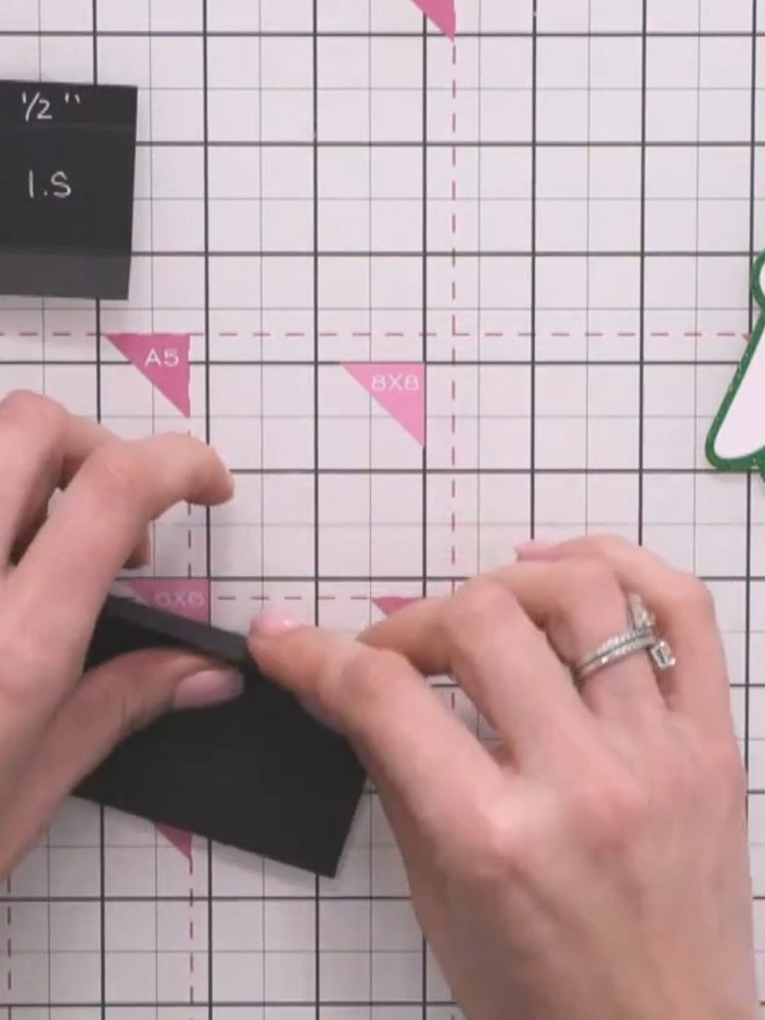 Step 7: Snip into the score lines at the corners of the black card to create flaps for folding. Make small cuts where 