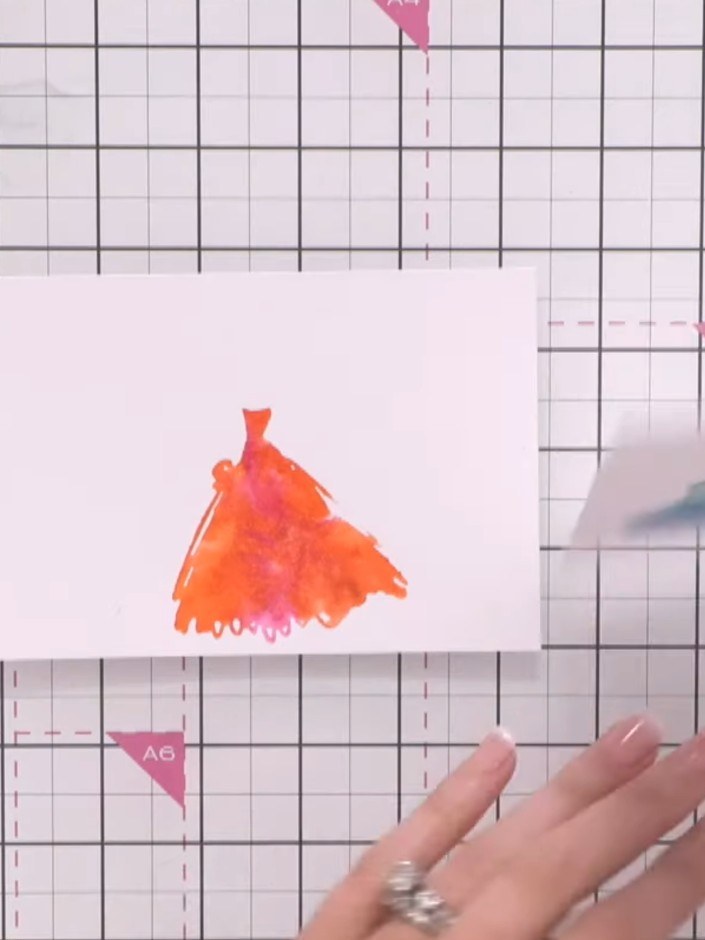 Step 7: Once the watercoloured gown is completely dry, ink the outline portion of the dress stamp in black ink and sta