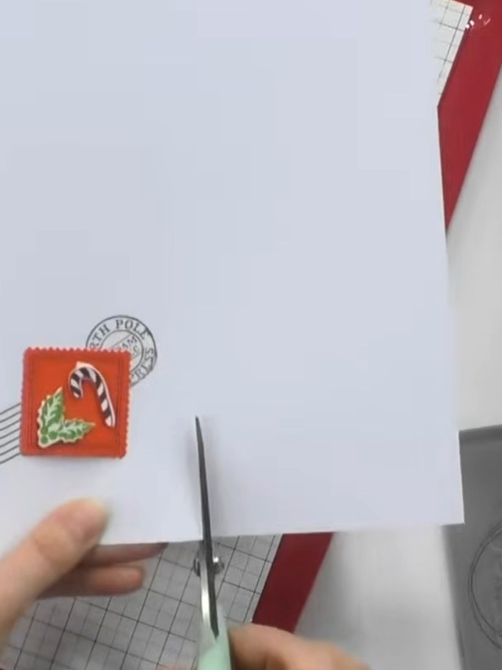Step 6: Trim the layered card down to size using the scoring board and trimmer. Cut away the excess white card to crea