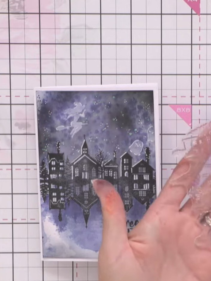Step 5: Using a white gel pen, add highlight lines down the left side of the building windows on the stamped cityscape