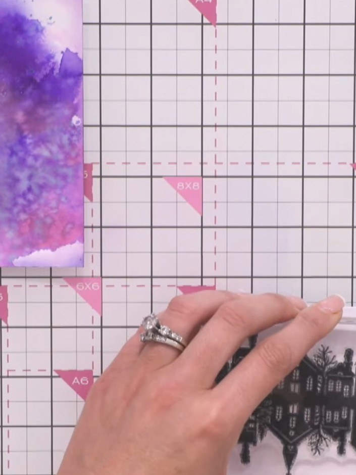 Step 9: Optional: Use a brush with water to gently blur the base of the stamped building image, creating a soft water 
