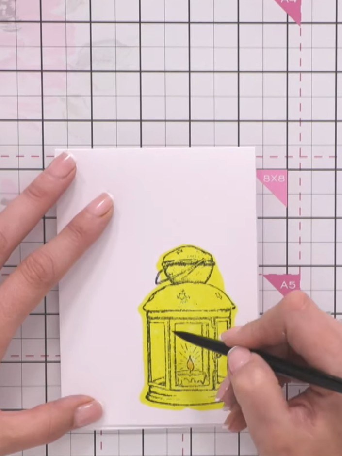 Step 10: Add detail to the lantern image using a fine black pen, drawing lines and shading to enhance the stamped desig