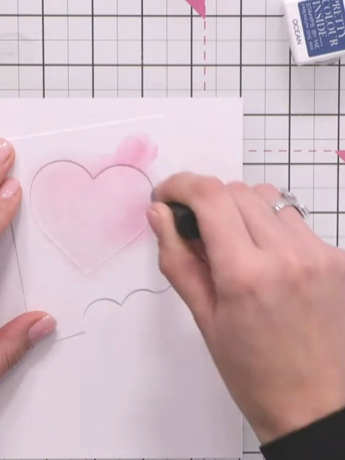 Step 4: Blend pink ink through the heart stencil using a blending brush. Start at the edges and work darker around the