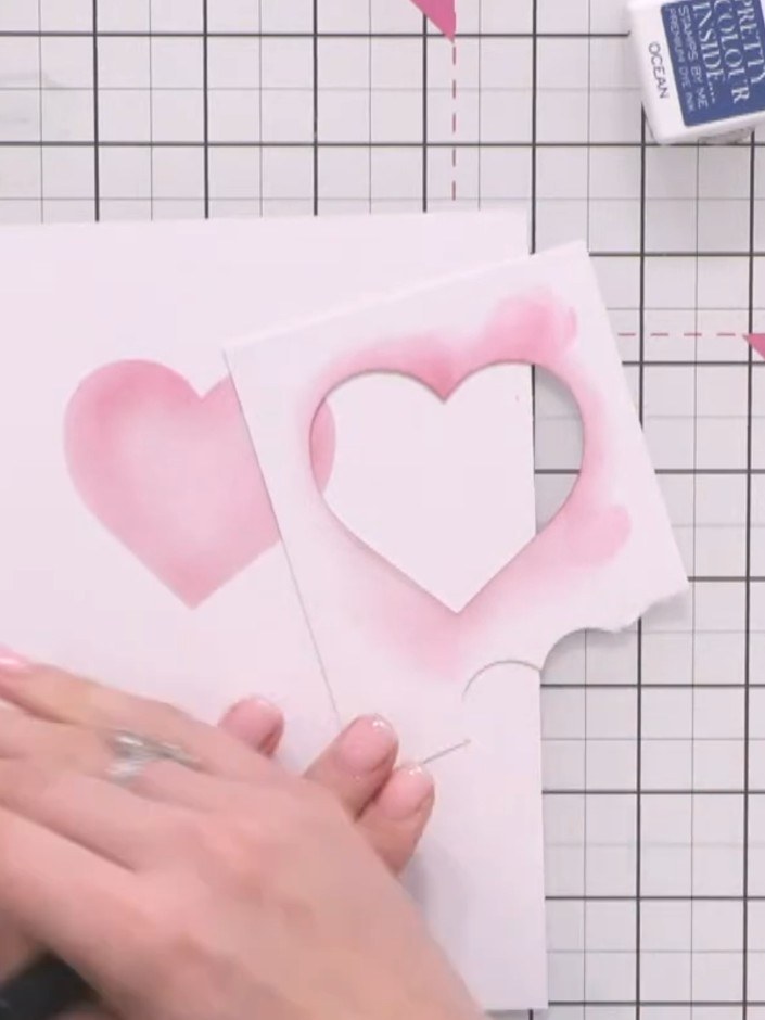 Step 5: Move the stencil slightly to offset the position and apply purple ink through the heart stencil to create a se