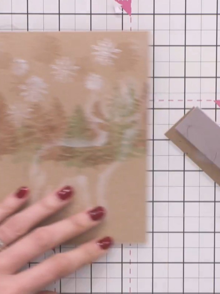 Step 12: Cut a thin strip from the patterned paper. Position it horizontally across the centre of the card to create a 