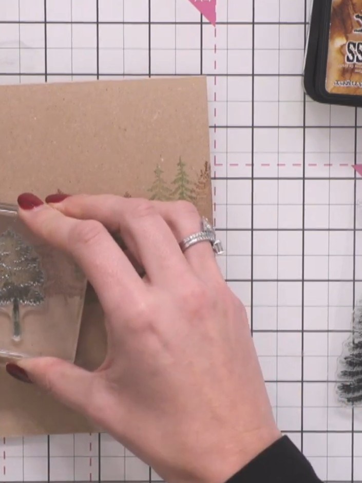 Step 5: Stamp tree designs across the lower portion of the card using brown, green and orange inks to create a forest 