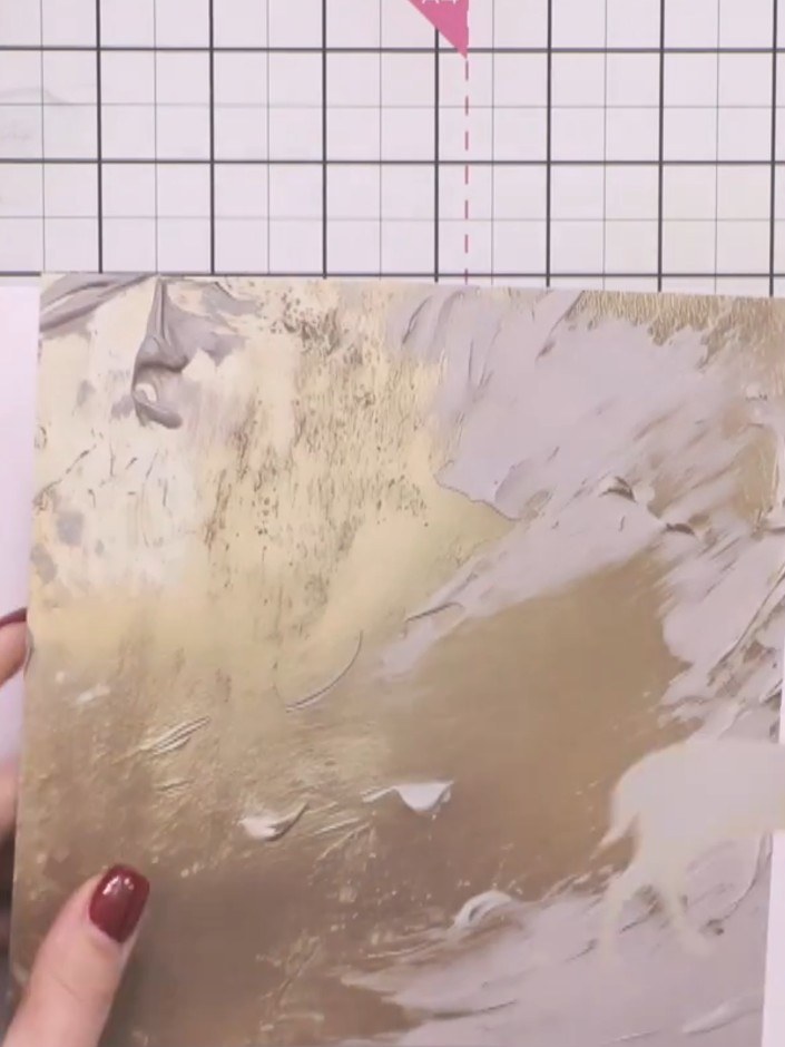 Step 8: Use the stag stencil to draw around the outline onto a piece of gold and grey patterned paper. Position the st