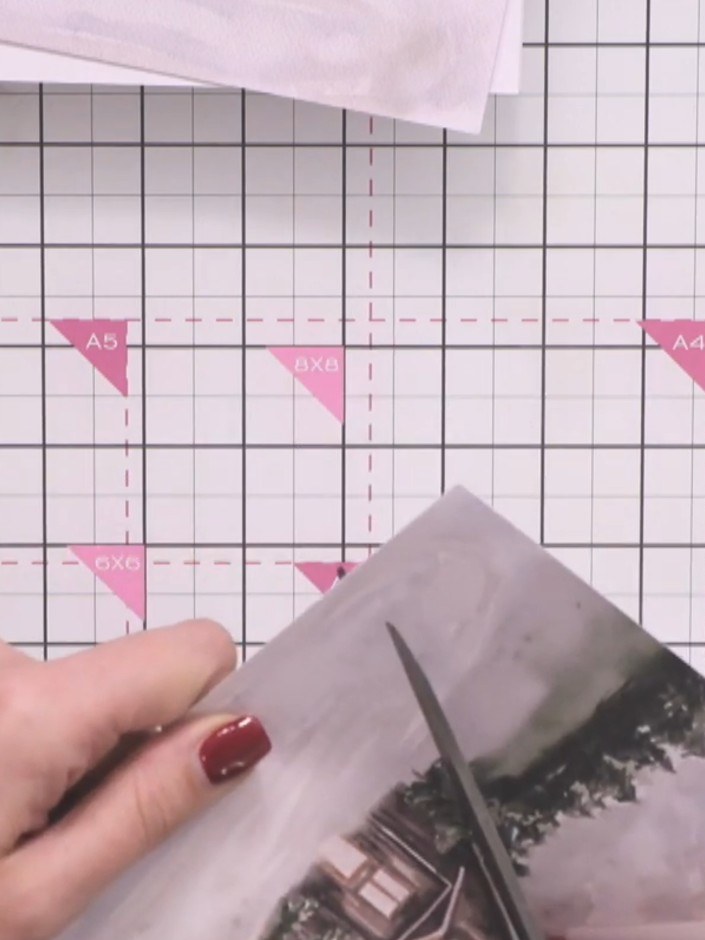 Step 2: Using scissors, carefully cut out the cabin image from the patterned paper, ensuring you leave the tree elemen