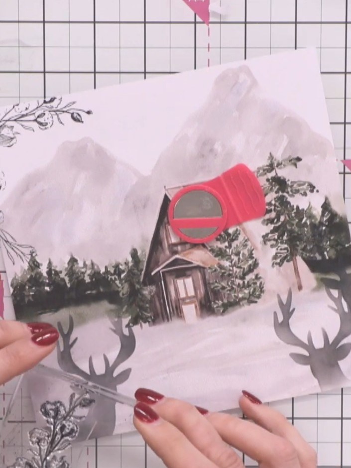 Step 6: Stamp the cotton flower border stamp over parts of the stag silhouettes to push them into the background and a