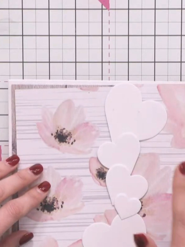 Step 5: Carefully trim away the excess patterned paper around the white heart shapes so that the heart outline is visi