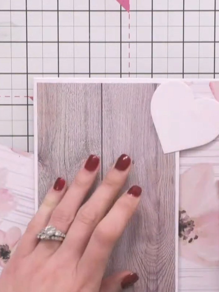 Step 7: Position and glue the heart pieces onto the card, allowing them to extend beyond the top edge of the card base