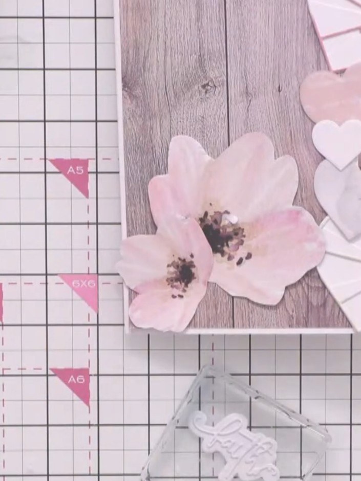 Step 7: Position the layered sentiment over the fussy-cut flowers on your card front. Arrange the die-cut elements inc