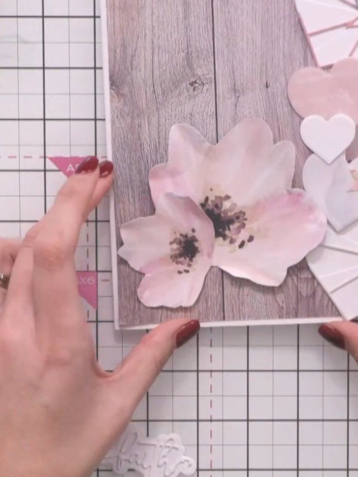 Step 8: Glue all the elements in place on the card front, building up the layers with the pink flowers, white hearts, 