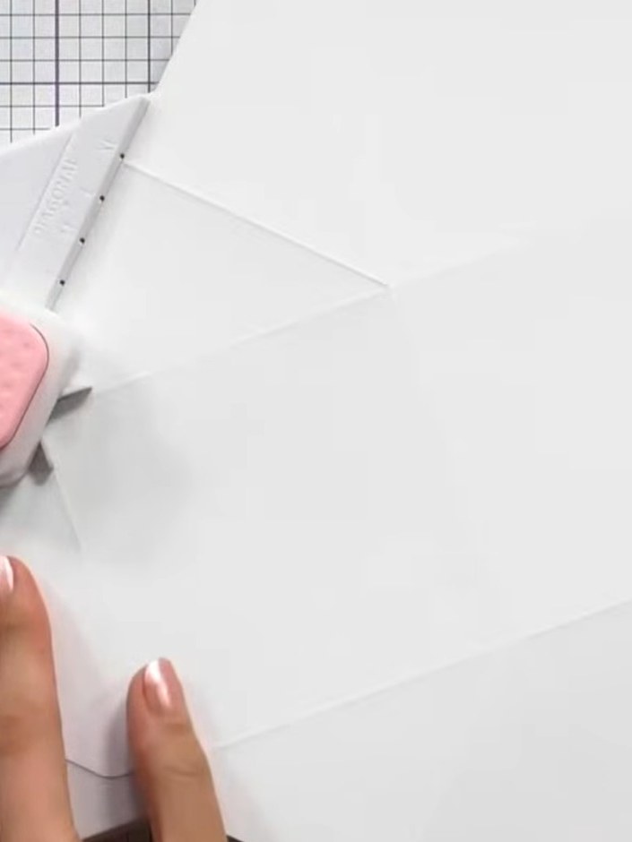 Step 5: Use the corner punch tool to punch out small triangles at the marked positions on the decorative paper. Positi