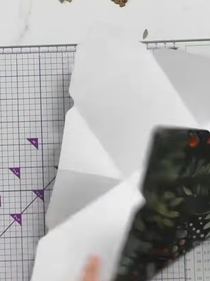 Step 8: Fold up the sides of the decorative paper along the score lines. Hook the eye closures together at each corner