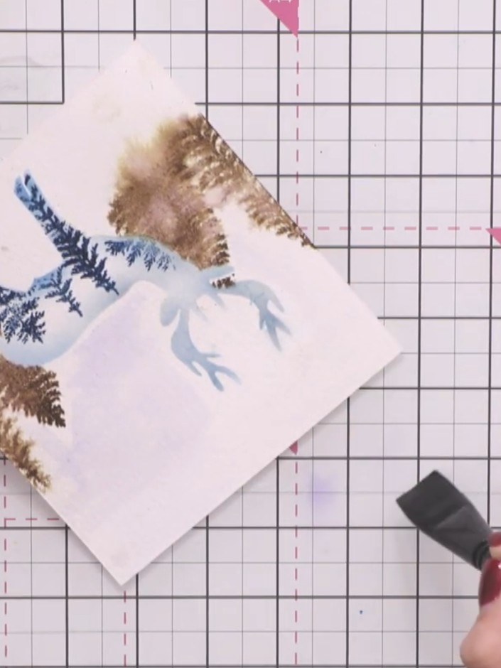 Step 9: Using a foam brush, lightly paint blue ink across the card in horizontal strokes, working close to the stencil