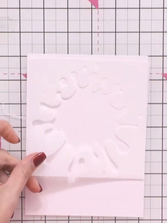 Step 1: Position the splat formation stencil on your white cardstock and line it up where you want the design to sit. 