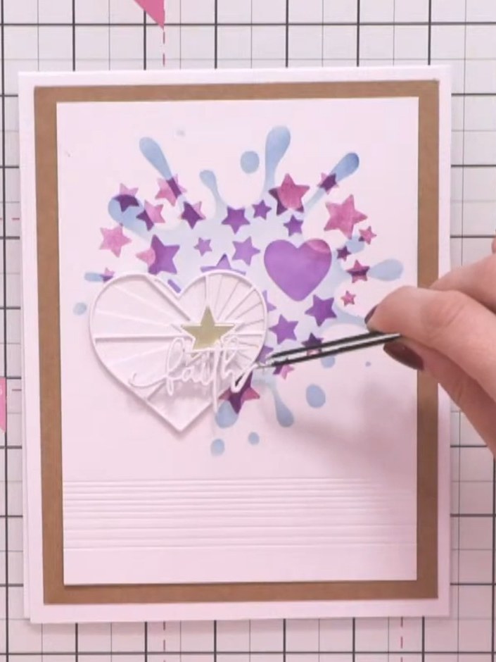 Step 12: Attach the layered 'Faith' sentiment to the card front, positioning it so it hangs off the edge of the heart e
