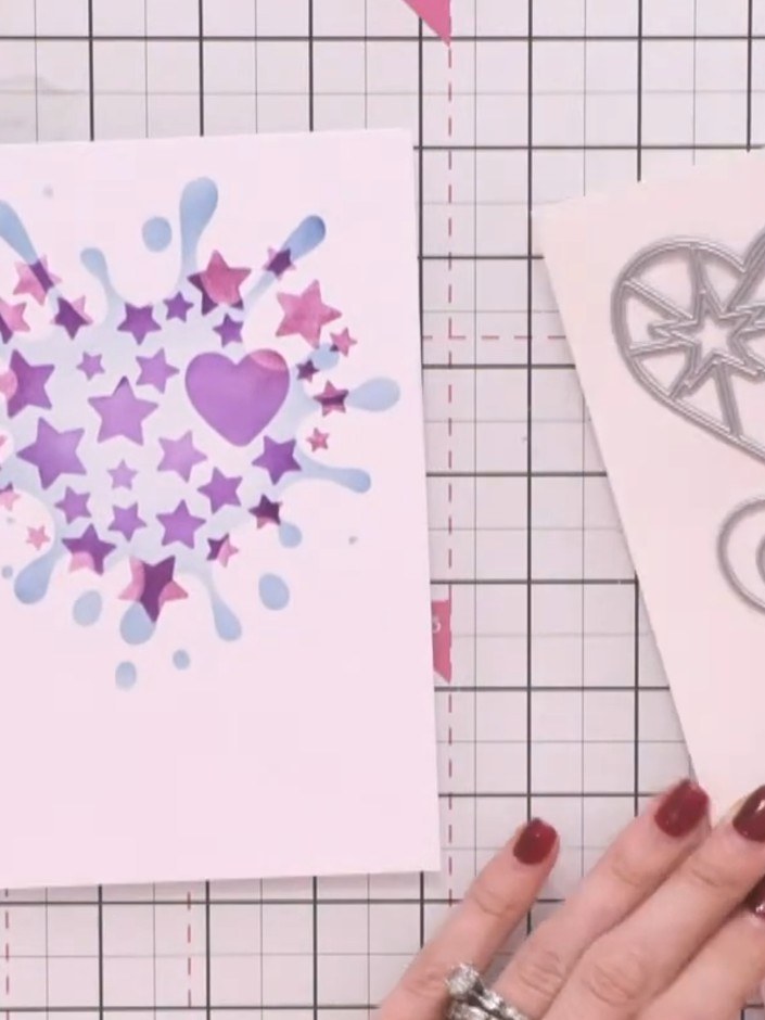 Step 8: Layer the die-cut heart pieces together, building up the star and heart elements to create dimension. Position