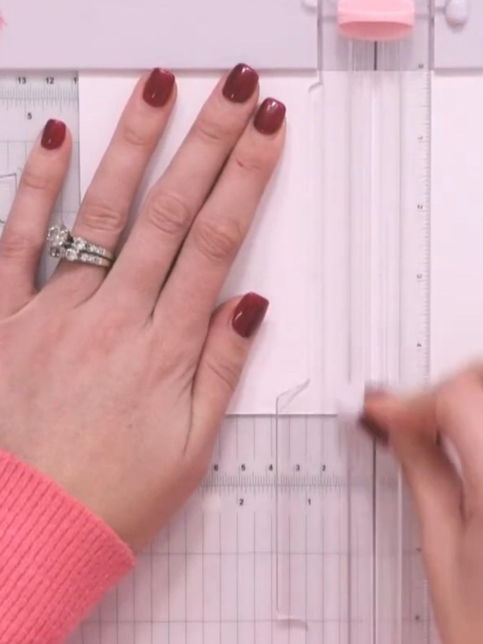 Step 2: Using the scoring tool on your scoring board, press firmly to create raised embossed lines across the white pa
