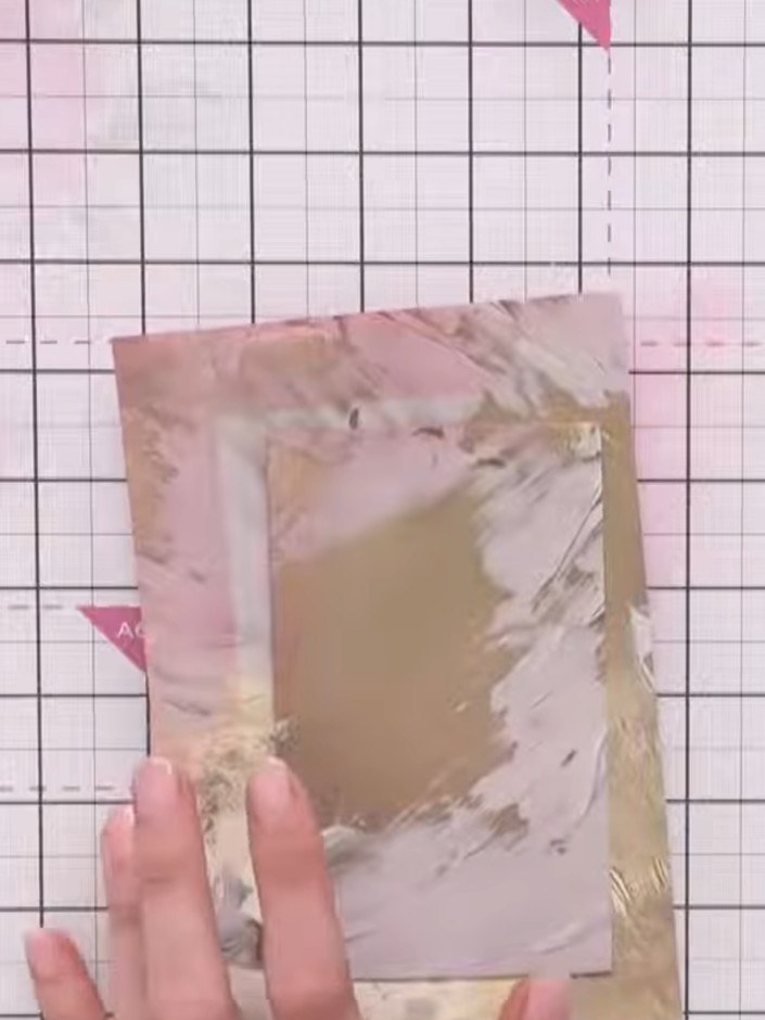 Step 3: Use a heat tool to dry the gesso and paint layers on your card panel. Hold the heat tool a few inches above th