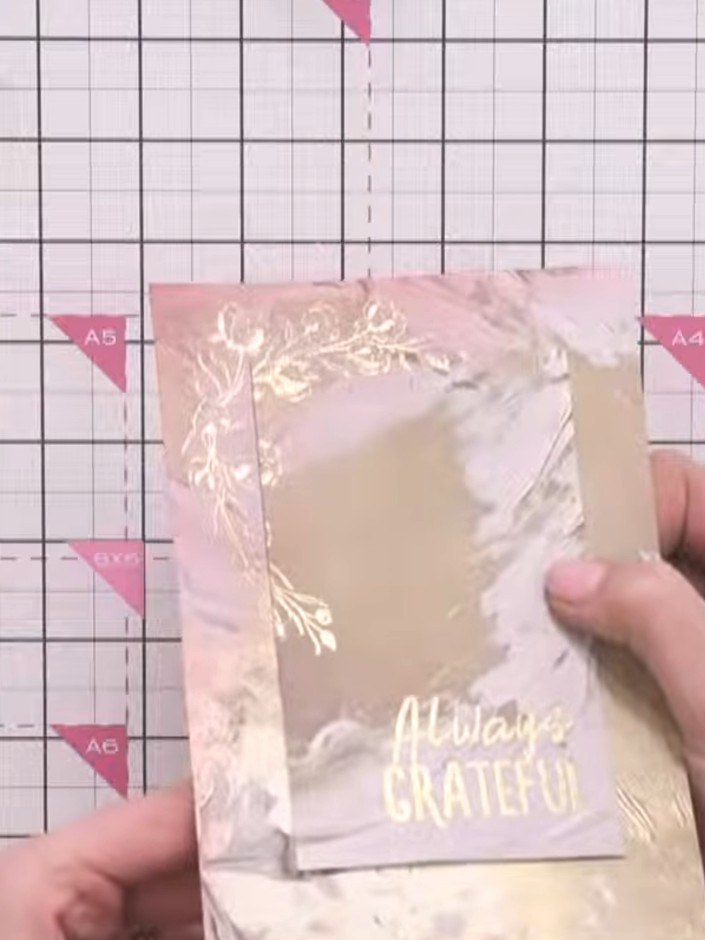 Step 8: Apply black ink to the edges of the patterned paper layer using an ink pad. This will help define the layer ag