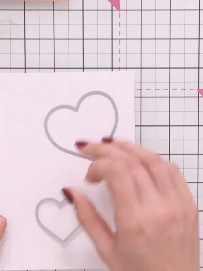Step 2: Die-cut the largest heart shape from copper-coloured cardstock. Position the die-cut heart on your white card 