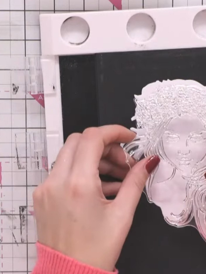 Step 2: Stamp one die cut shape with black ink using the Charlotte stamp. Hold the exterior of the die cut with a magn